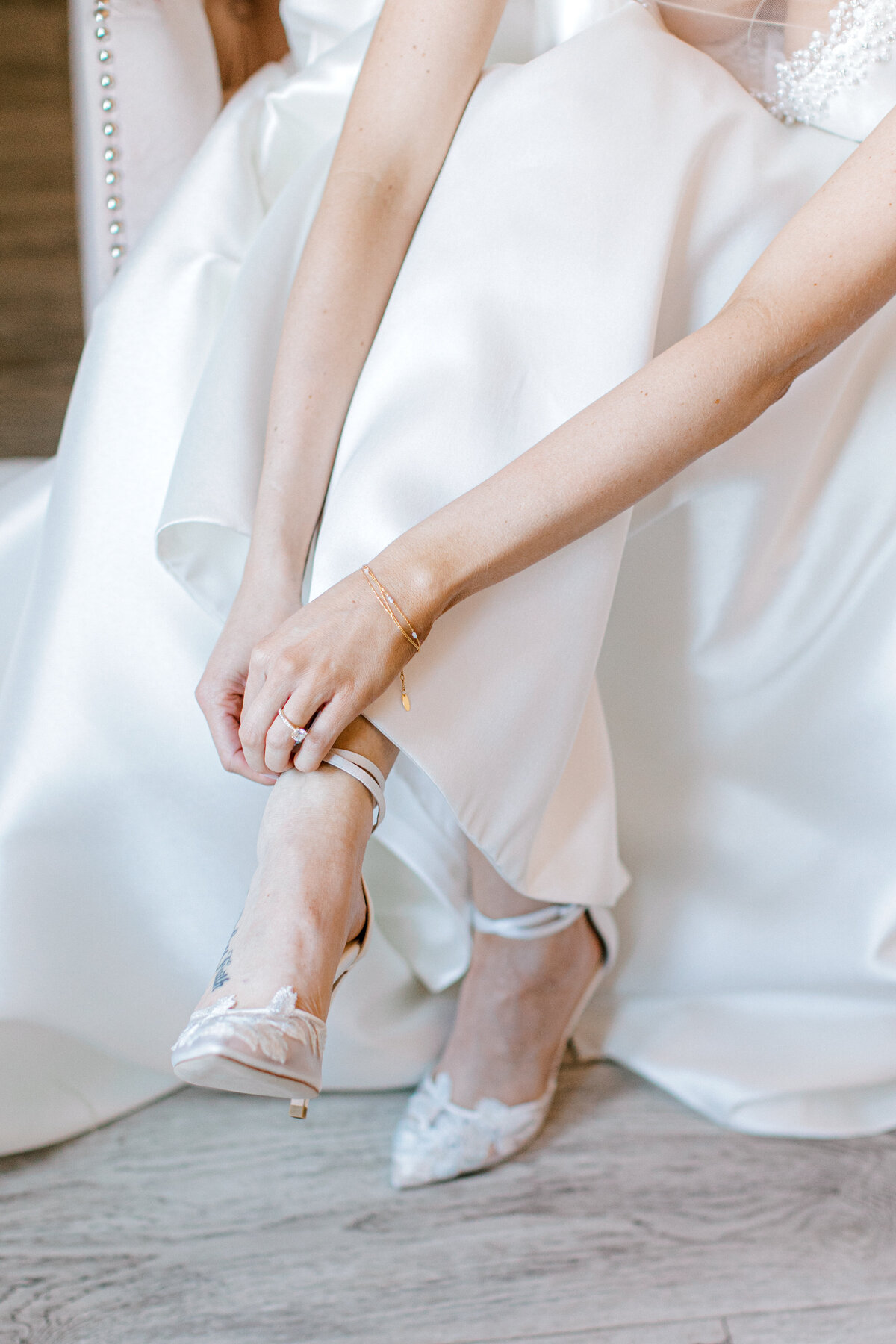 bride getting ready for the ceremony and putting on her wedding shoes