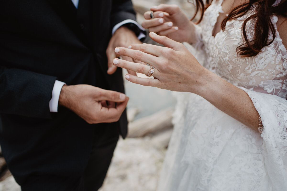 Jackson Hole Photographers capture bride putting ring on groom's finger