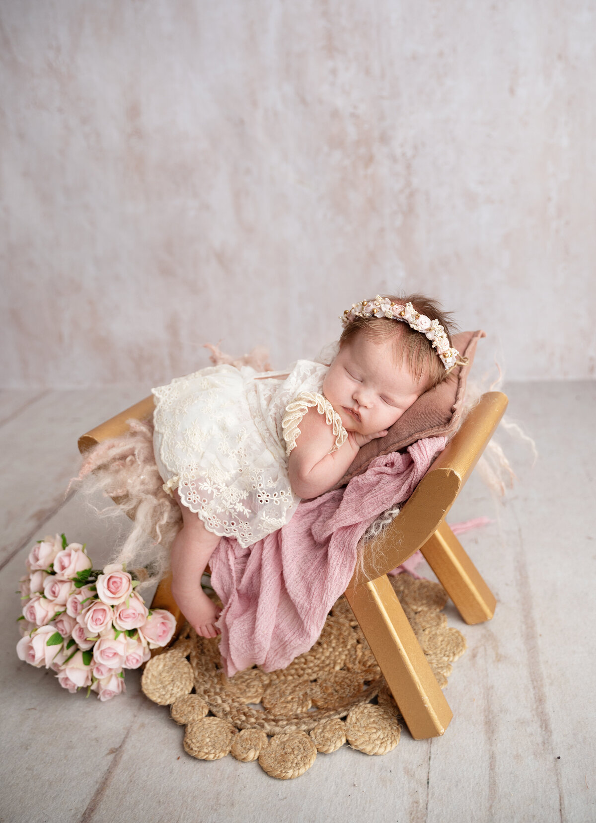 baby girl on a chair with flowers
