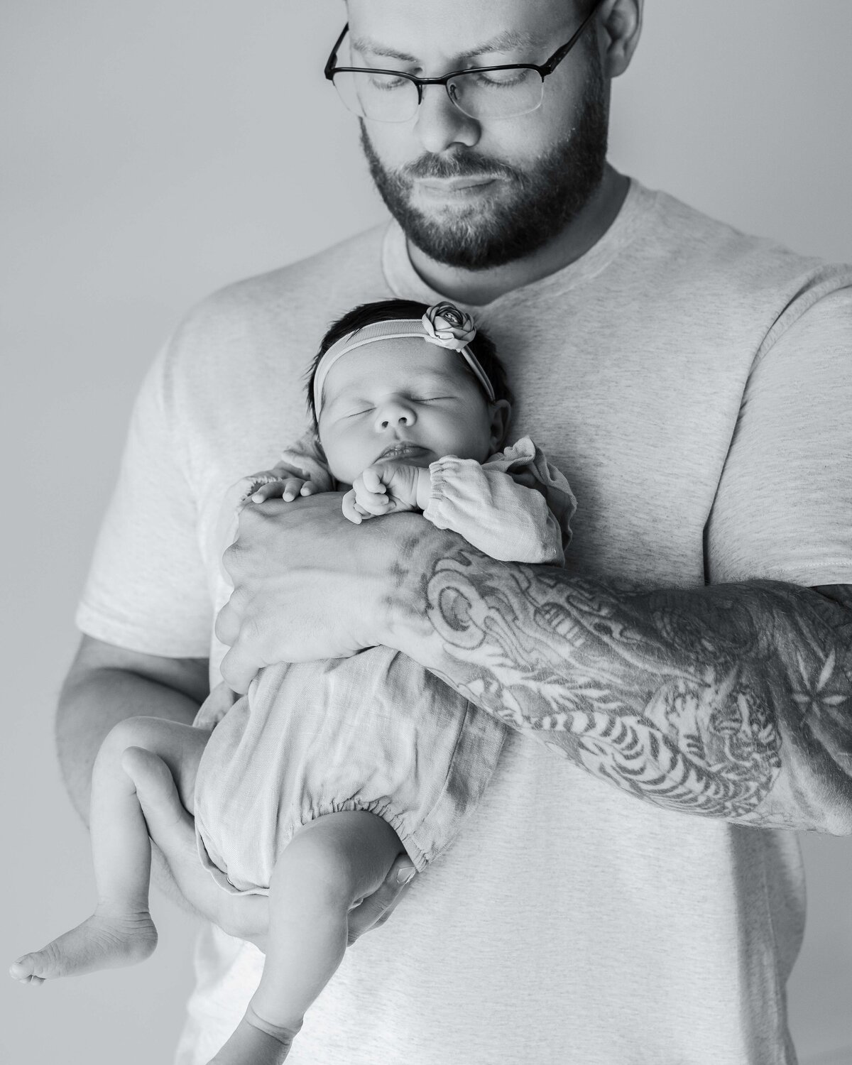 A  dad and his newborn baby by Daisy Rey Photography