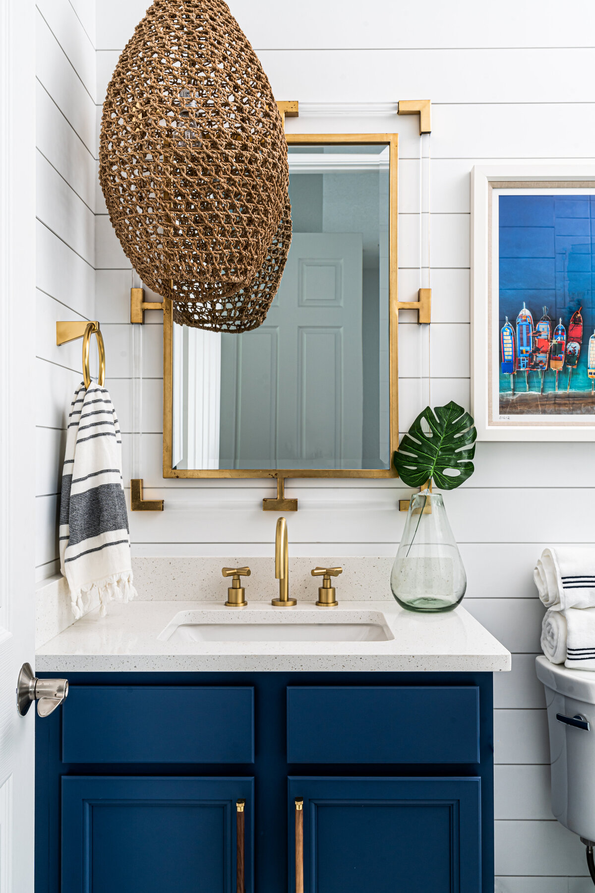 coastal home nautical guest bathroom with navy blue vanity Full Service Interior Design by Island Home Interiors Lake Nona 2