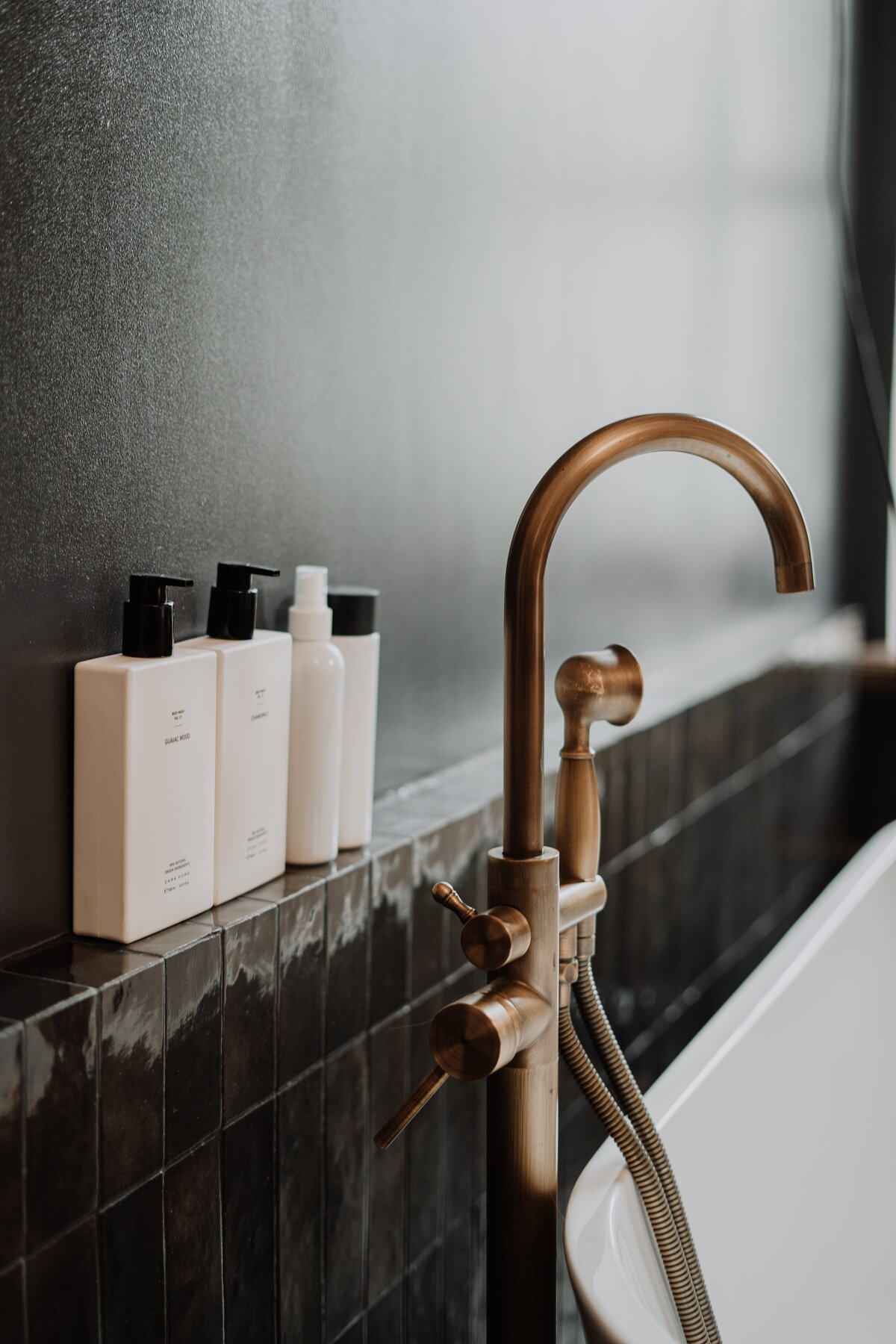 brass-faucet-with-white-ceramic-bathtub-4153144