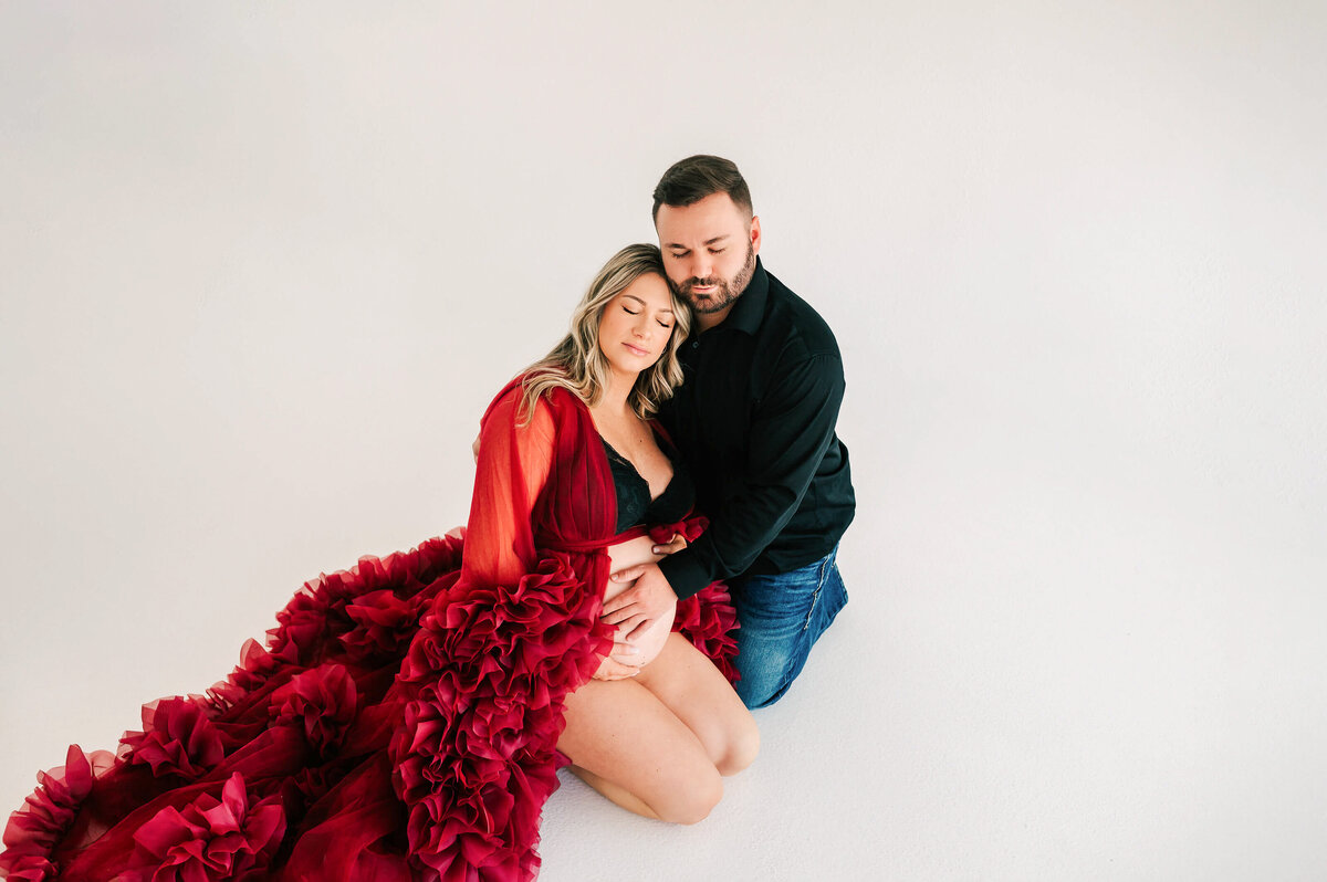 Springfield MO maternity photographer Jessica Kennedy of The XO Photography captures pregnant couple closing eyes kneeling on floor