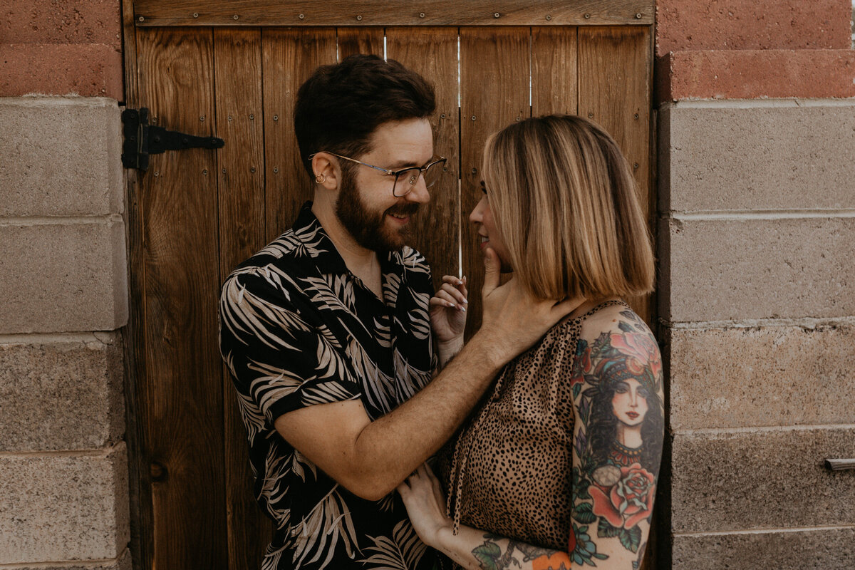 girl and boy holding each other on porch