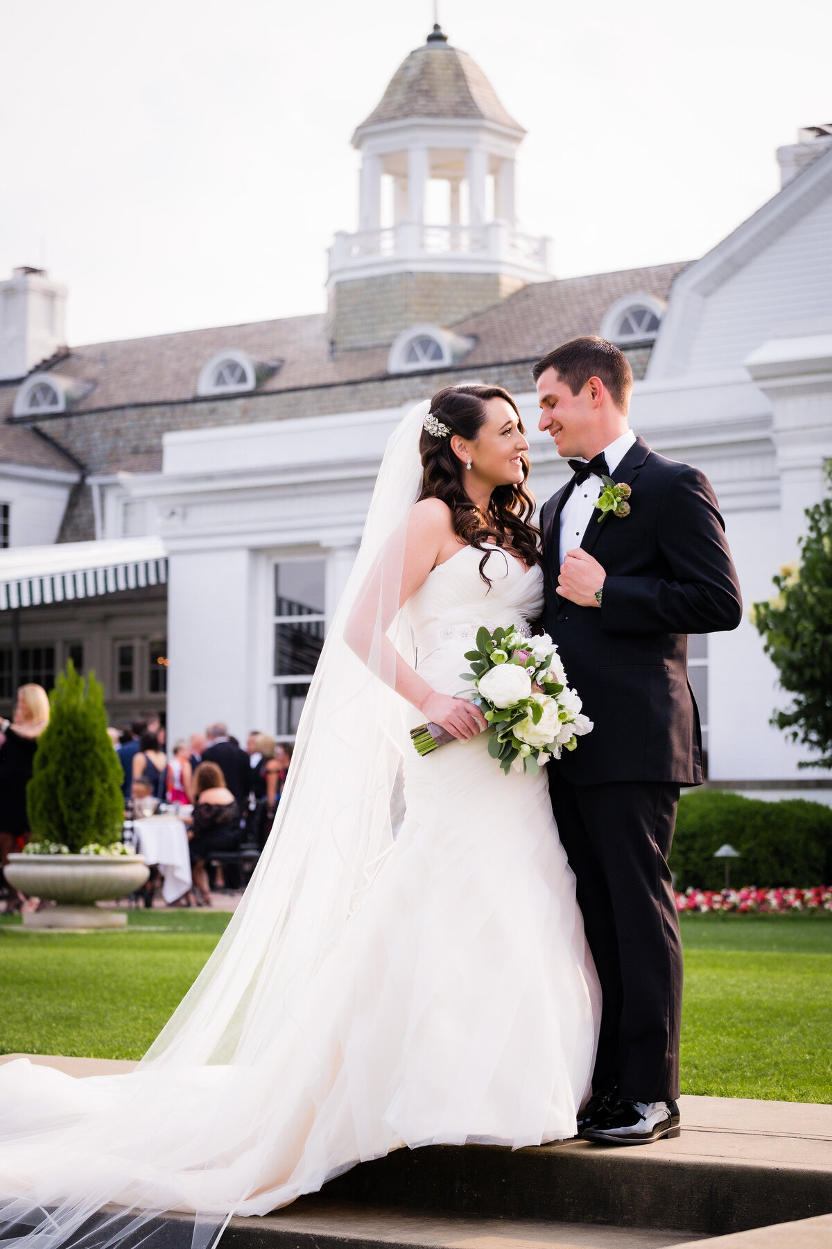 bride and groom in front of Allegheny Country Club in Sewickley