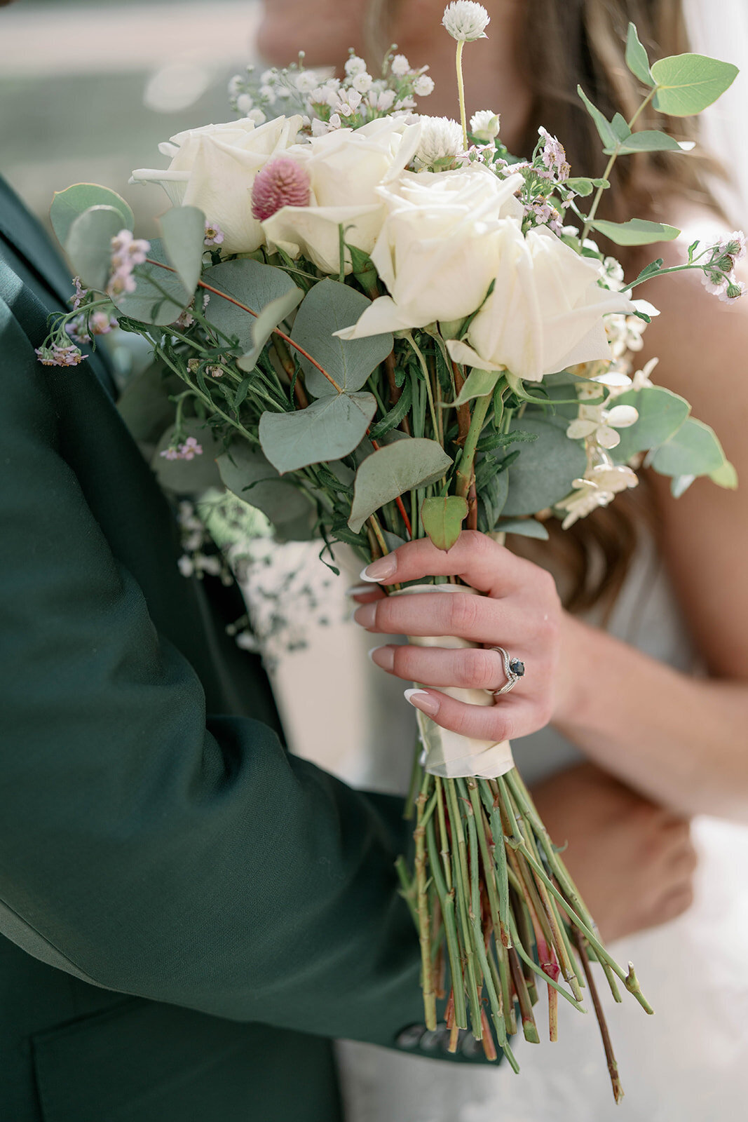 Close-up of the bride’s bouquet with her blue sapphire engagement ring from an Ivy House wedding in Saugatuck Mich.