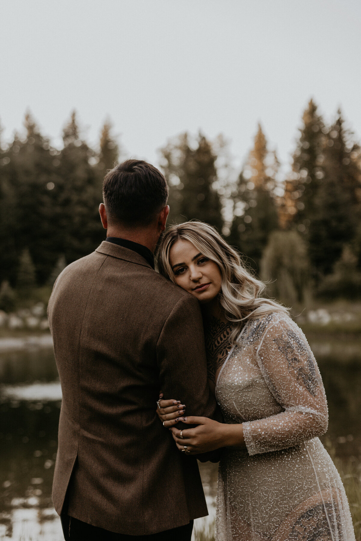 bride and groom together in front of a pond in Montana
