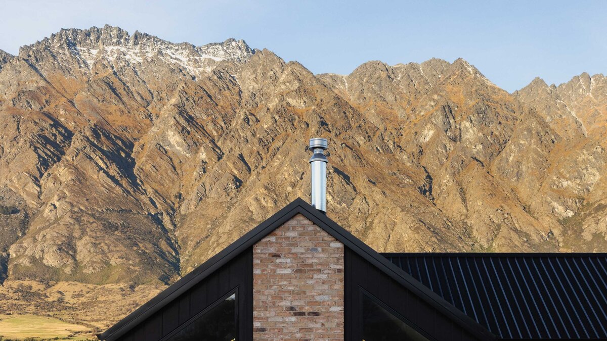 The roof line of a home built by Twin Peaks Construction in Hanleys Farm with the Remarkables mountain range in the background.