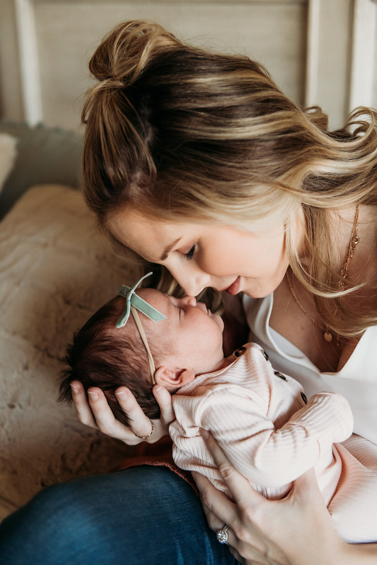 Newborn Photographer, Mom giving baby girl a nose kiss.