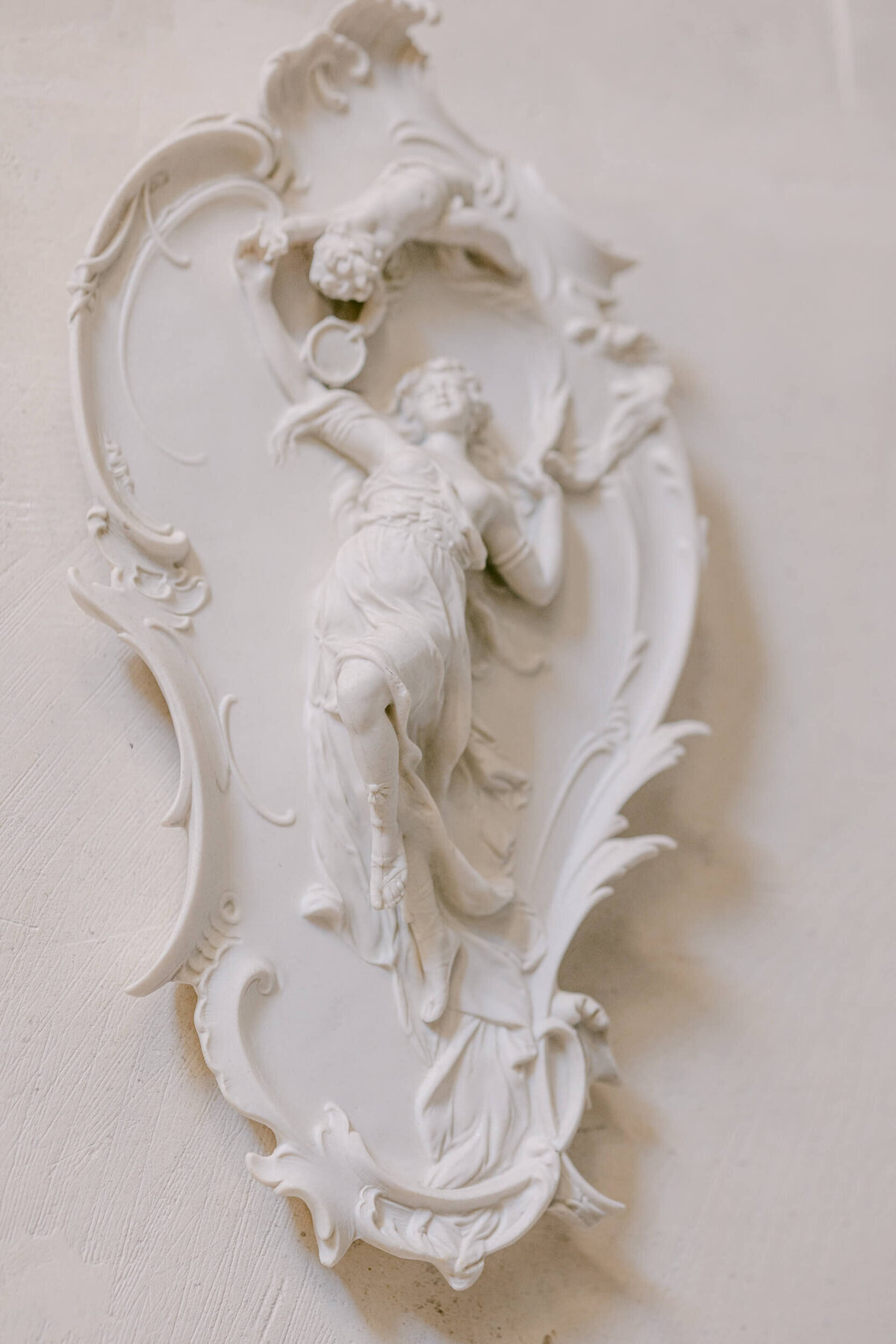 A wedding photo of a stone sculpture at Chateau de Jalesnes in France