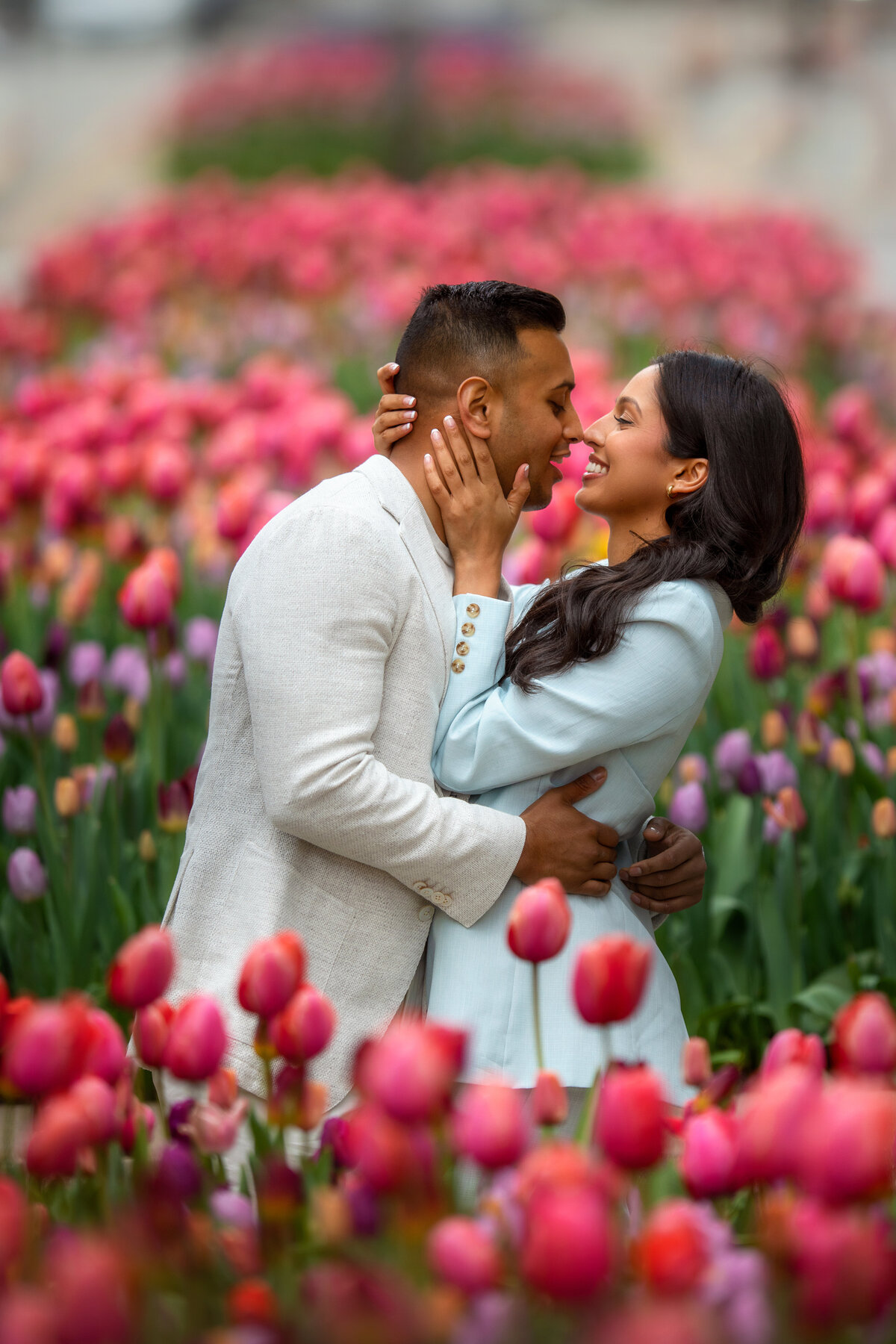 Engaged couple in the middle of  Michigan Avenue street in downtown Chicago surrounded by pink flowers