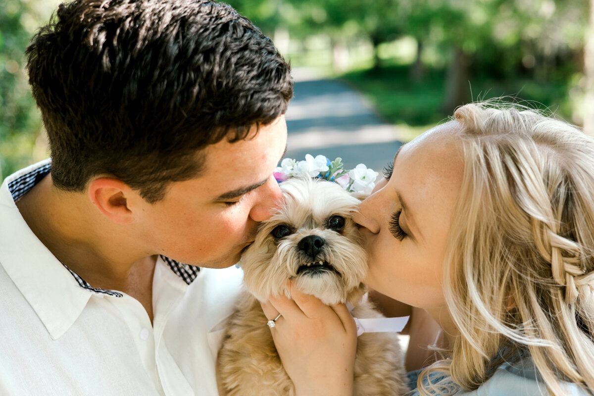 couple kissing dog