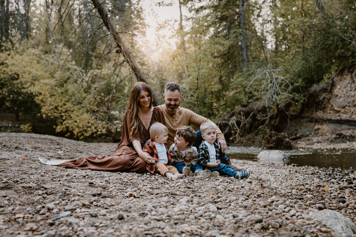 Family sitting by a stream