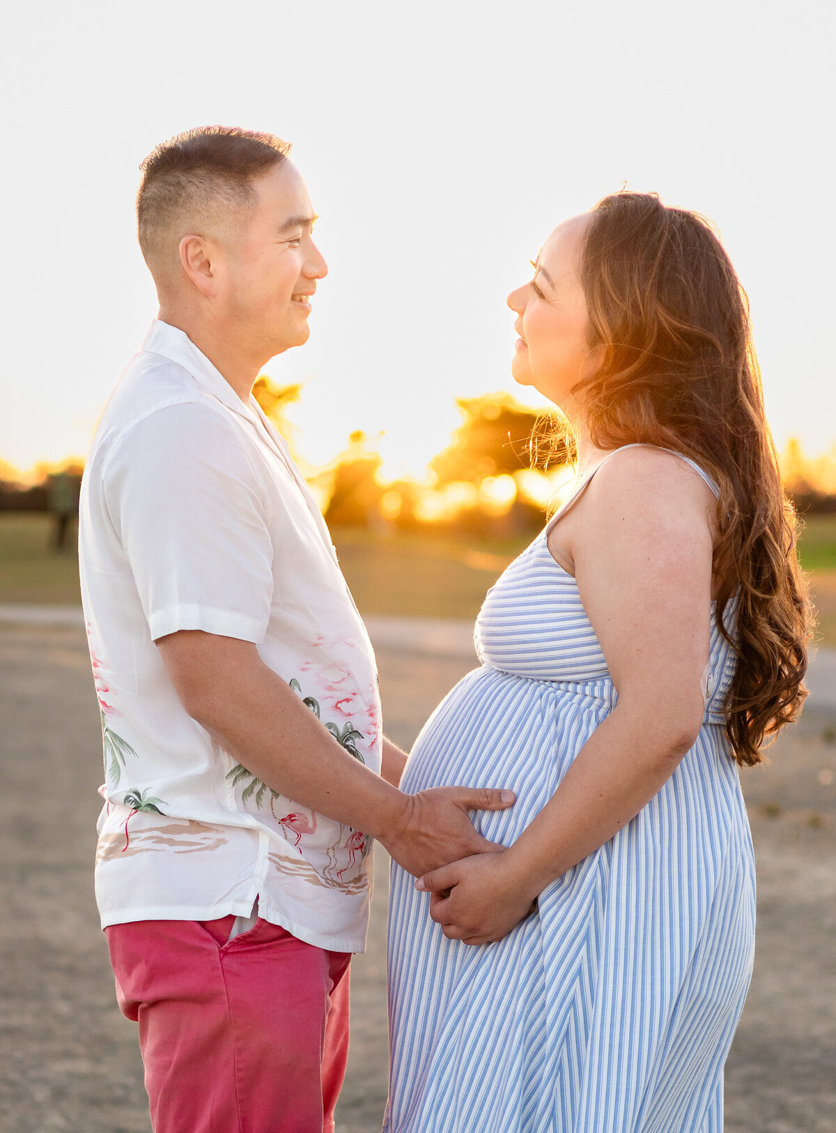 Couple facing each other and holding the baby bump as the sun sets — Bay Area Maternity Portfolio - Ellobelle Photography Family Photographer