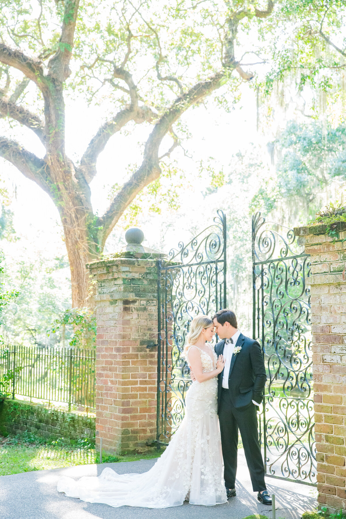 bride and groom share romantic moment at legare waring house in charleston sc