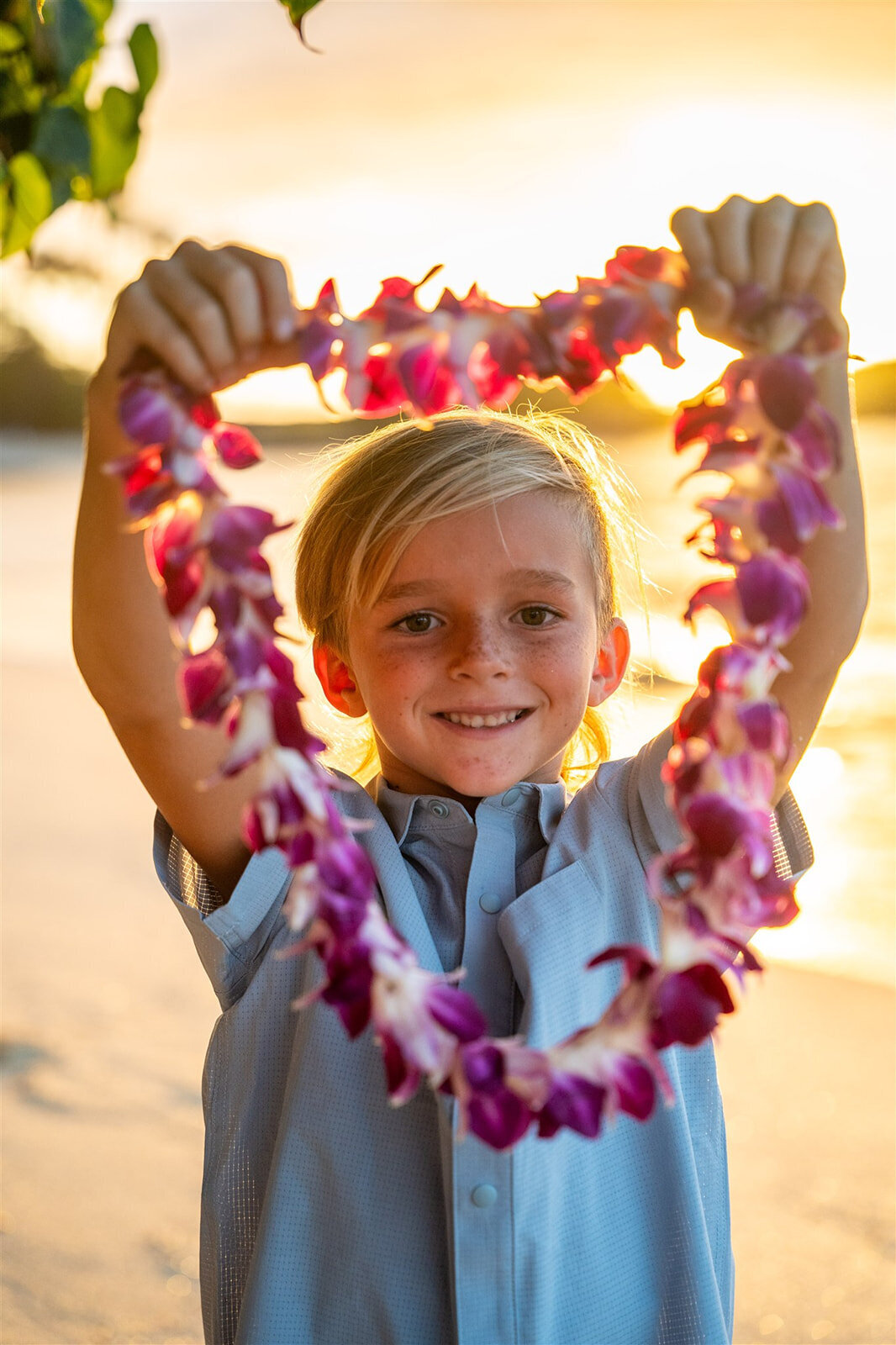 family pictures in Hawaii of a little boy with flower lei