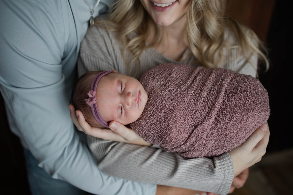 Sweet Baby Girl Snuggled by Mom and Dad