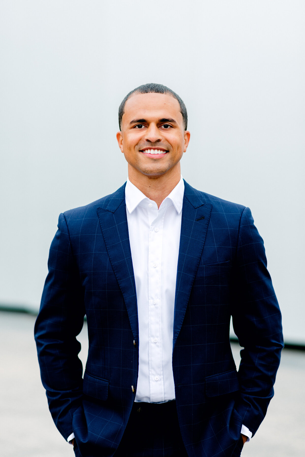 Man standing and smiling for professional headshot