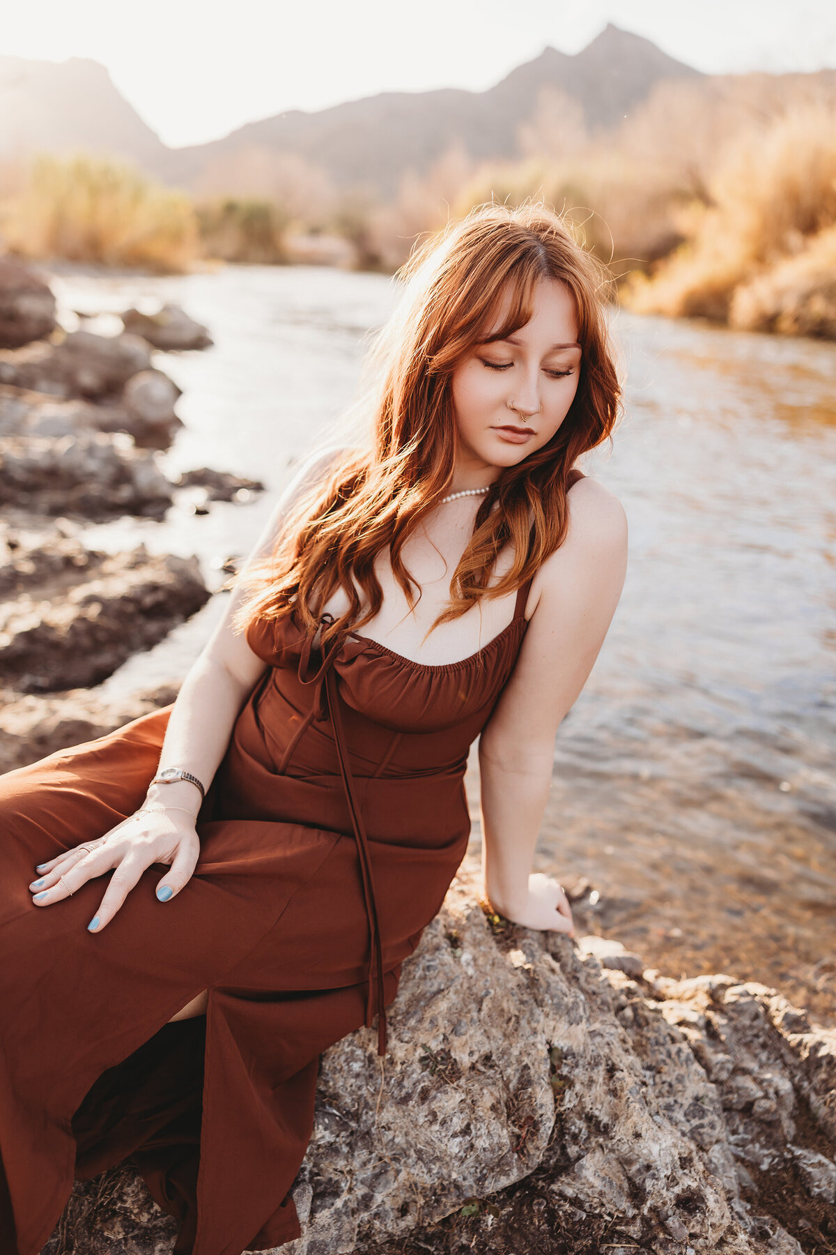 Girl with red hair posing at salt river for senior session by phoenix photographer