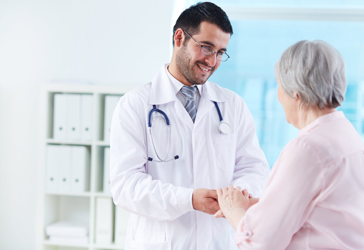 Doctor helping senior patient Apex benefits Chronic Care