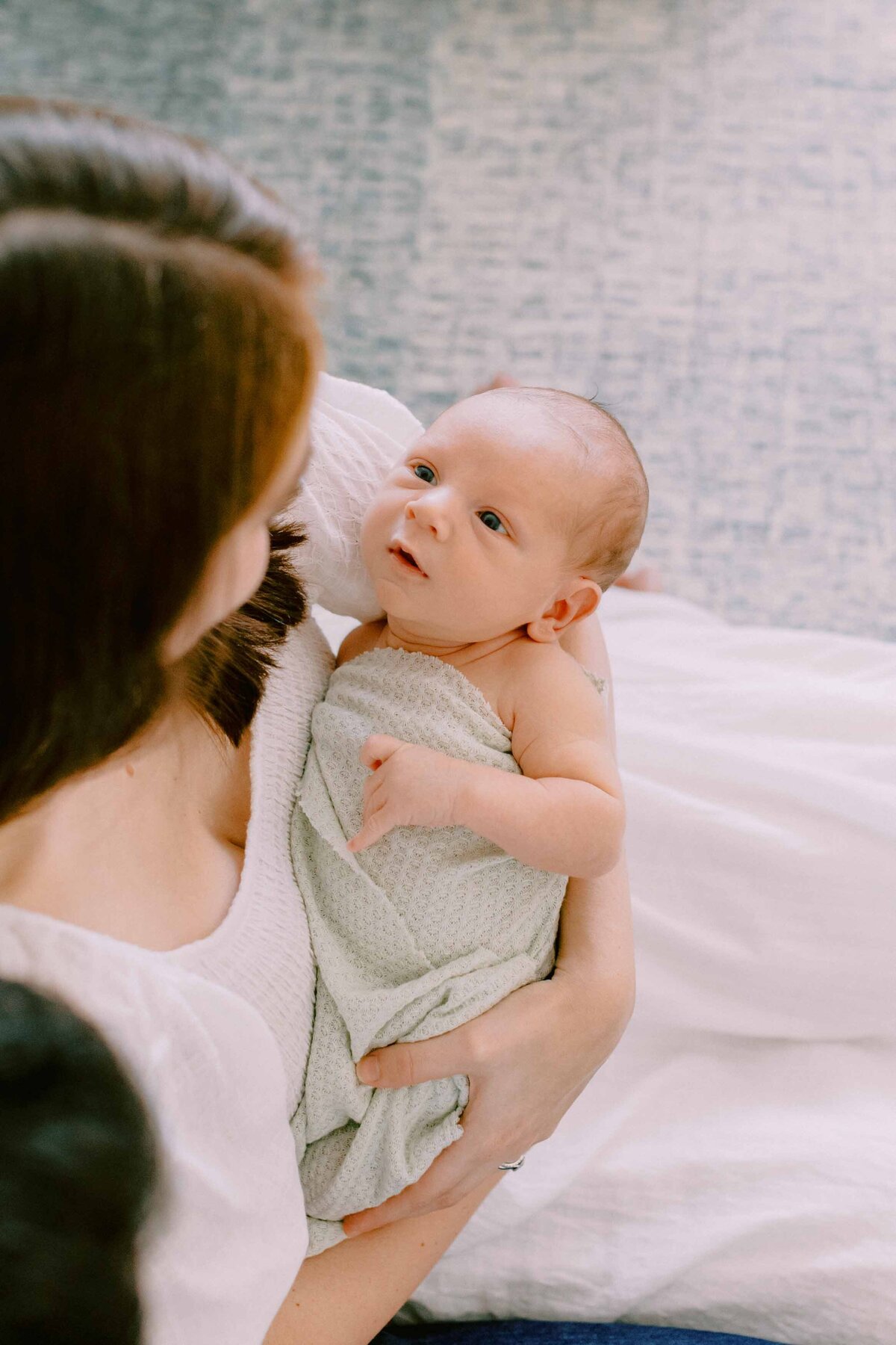 baby looking lovingly up at his mommy
