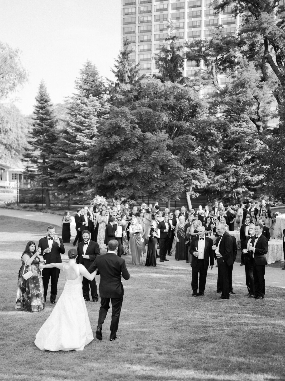 Black and white photo capturing guests in a celebratory moment.