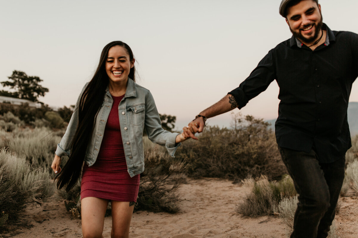 engaged couple running in Albuquerque