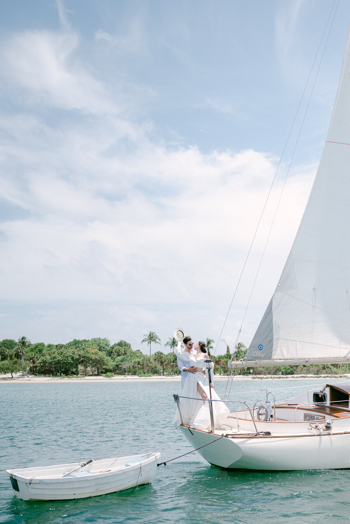 Bride hugging her groom on a sailboat
