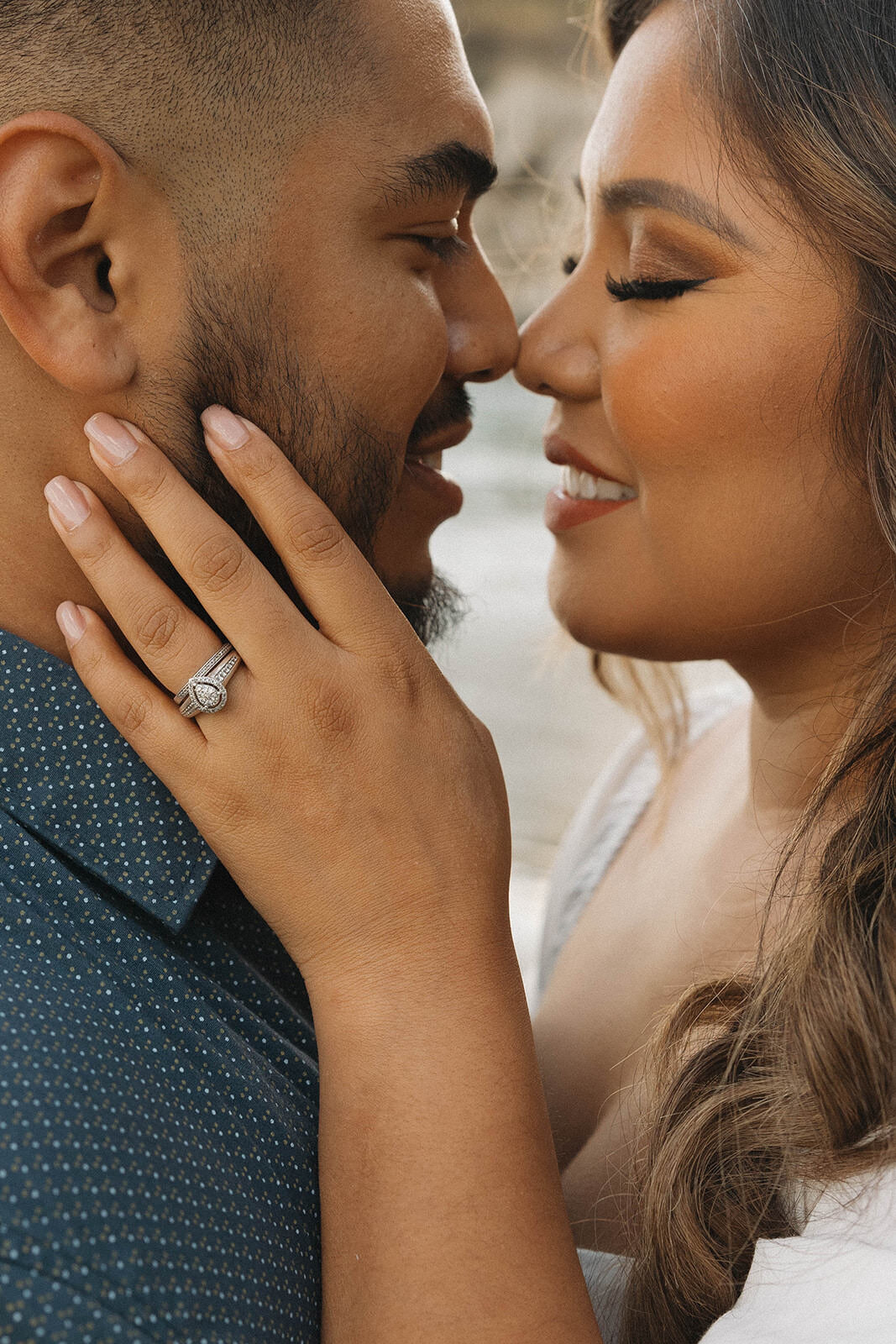 Close up of a couple about to kiss, ring on her hand