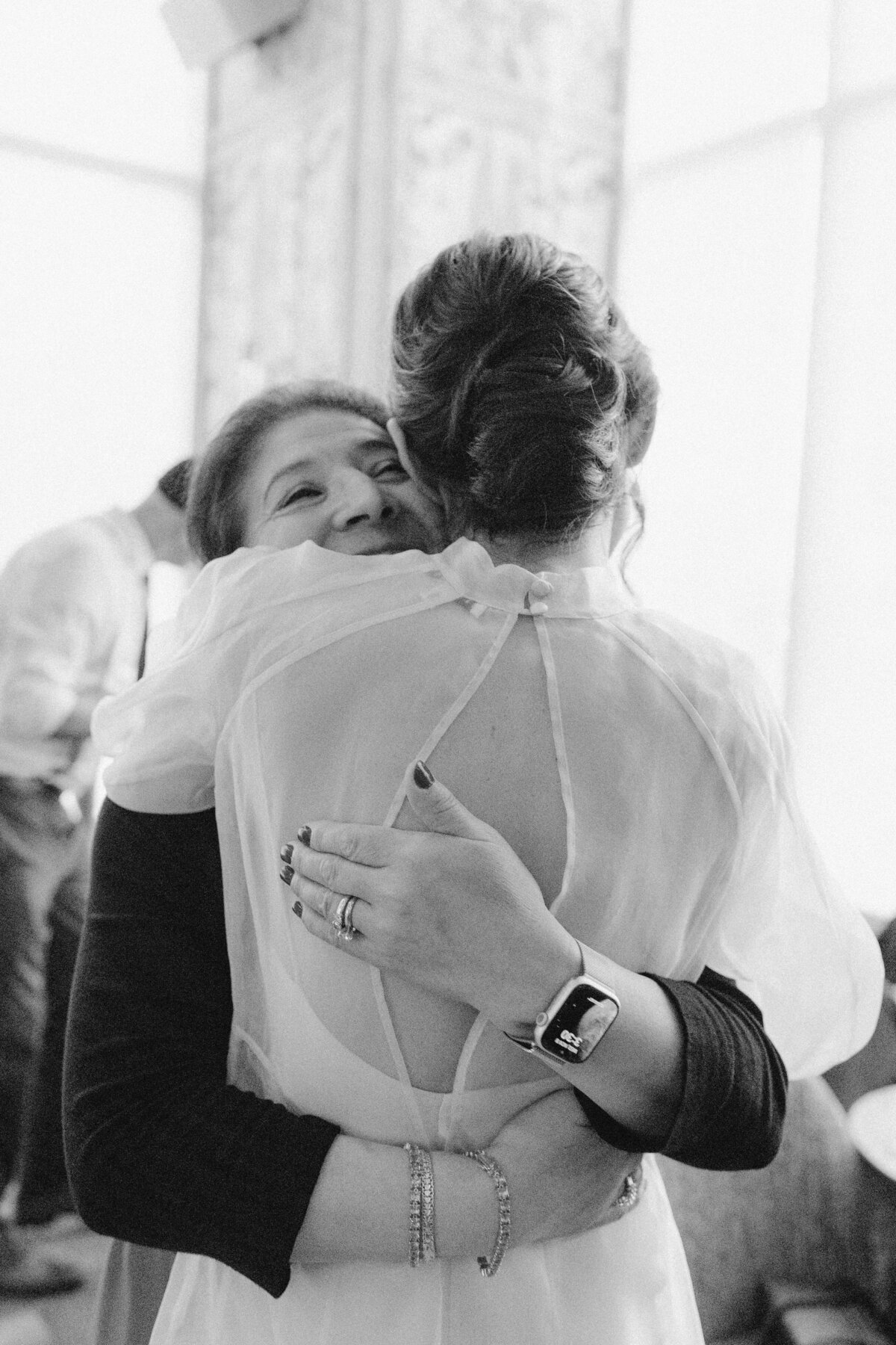 Bride hugging guest at wedding at Proper hotel in Austin