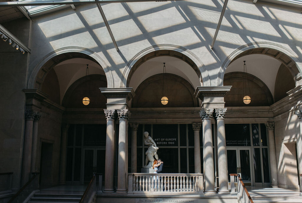 Engaged couple standing beneath arches in Chicago