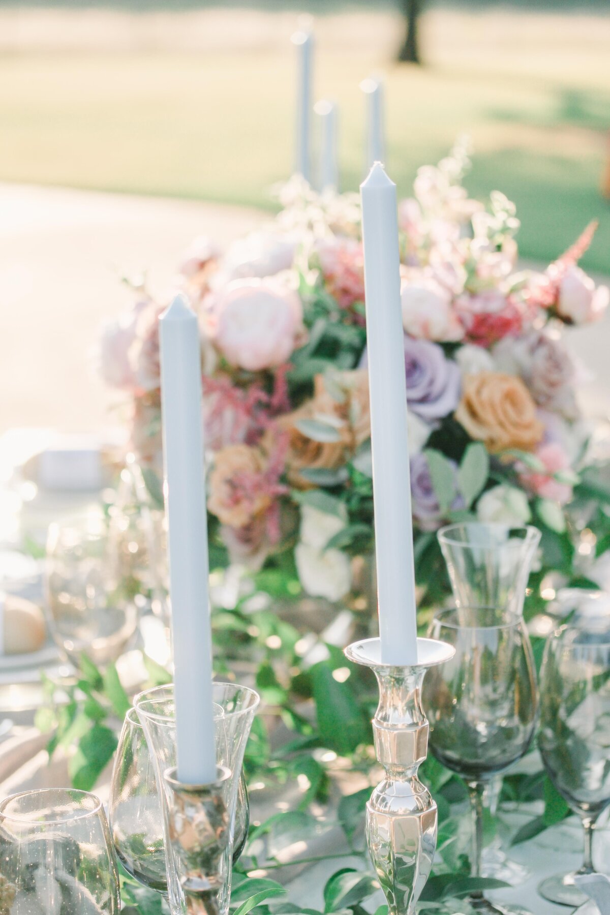 table top with greenery, taper candles, soft colored florals, french inspired design by Tulsa Wedding Planner, Bethany Faber