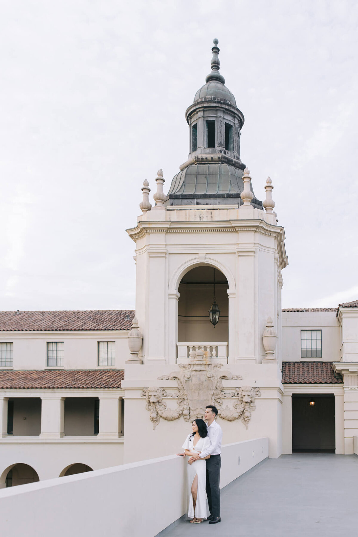 wide angle photo of couple with architectural background