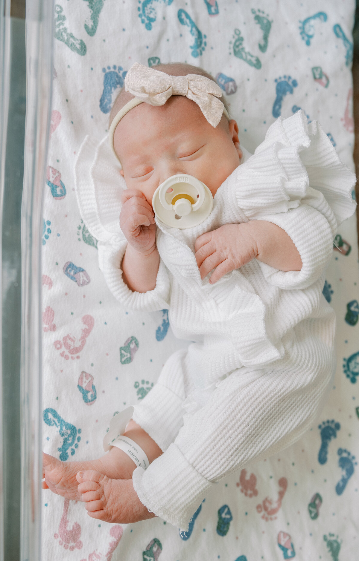 newborn in hospital bassinet