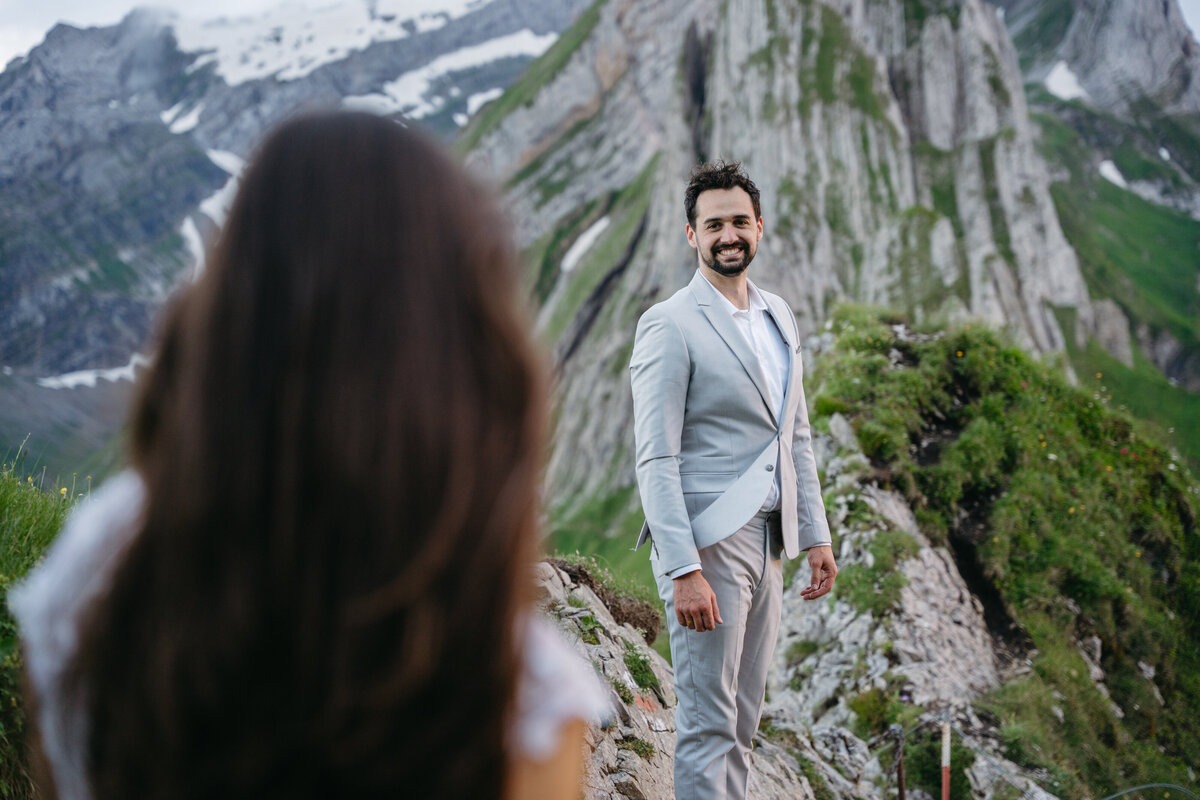 Groom looking towards bride during Switzerland elopement in the mountains