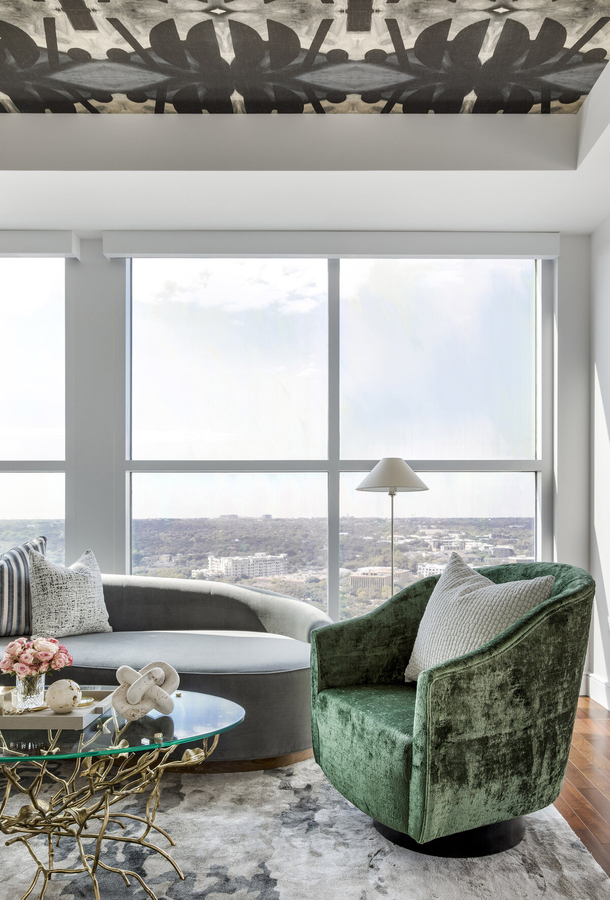 patterned ceiling in living room with green velvet chair