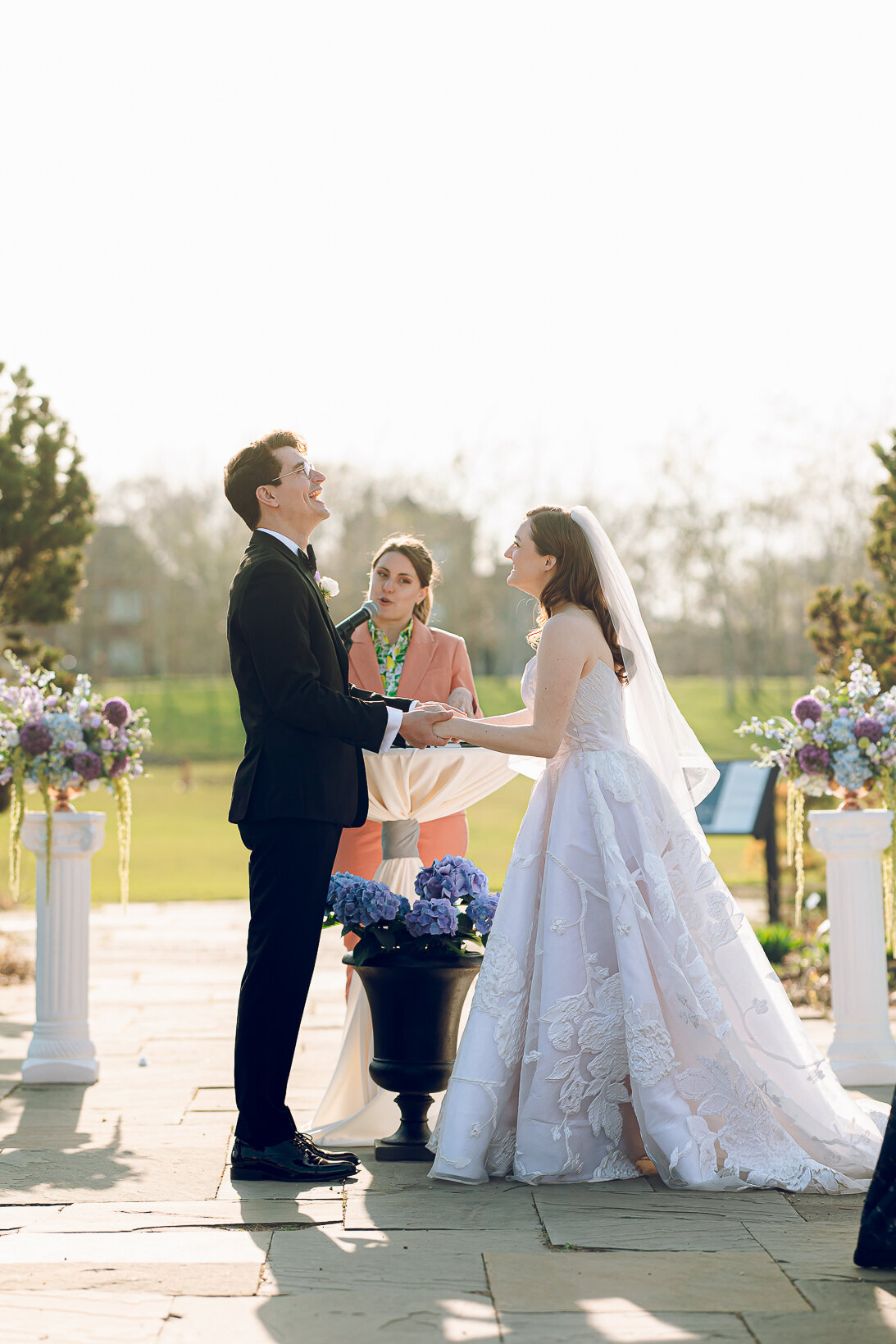 A couple laughs during their ceremony at the Garfield Park Conservatory in Chicago