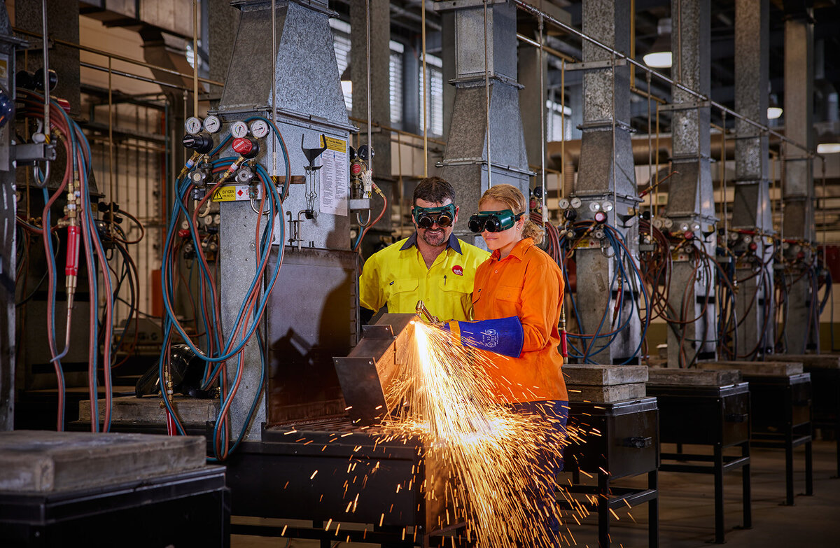 commercial photo shoot of tafe qld engineering teacher with student welding