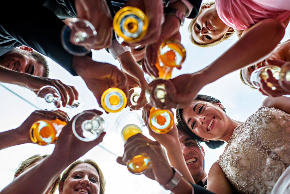 A bridal party cheers to the new couple.