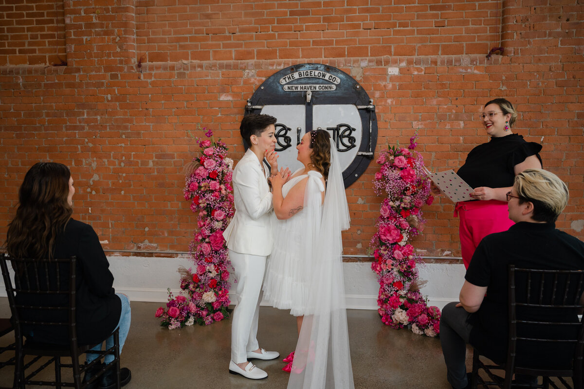 Brides at the wedding alter holding hands