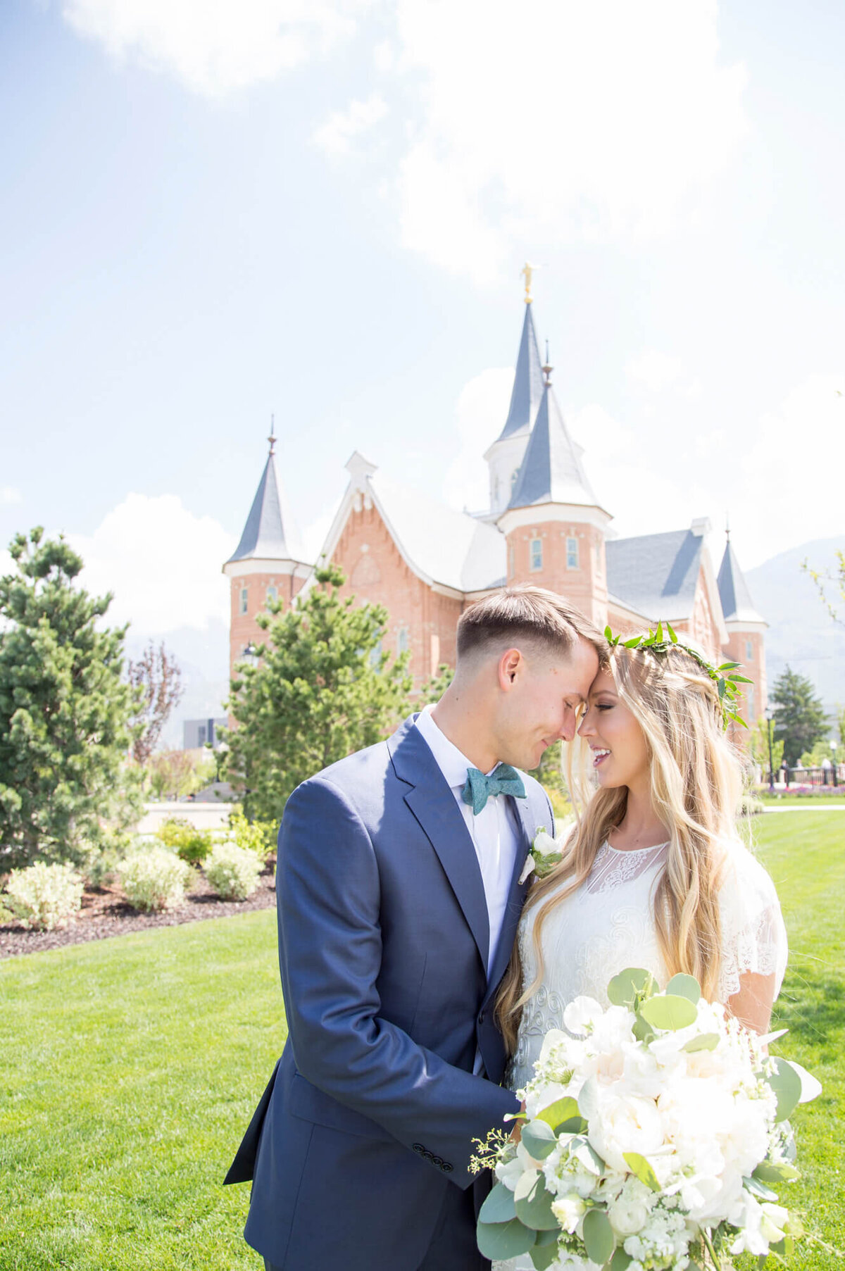 a wedding couple looking at each other in front of the provo city center temple, photo by Jessica Bowles