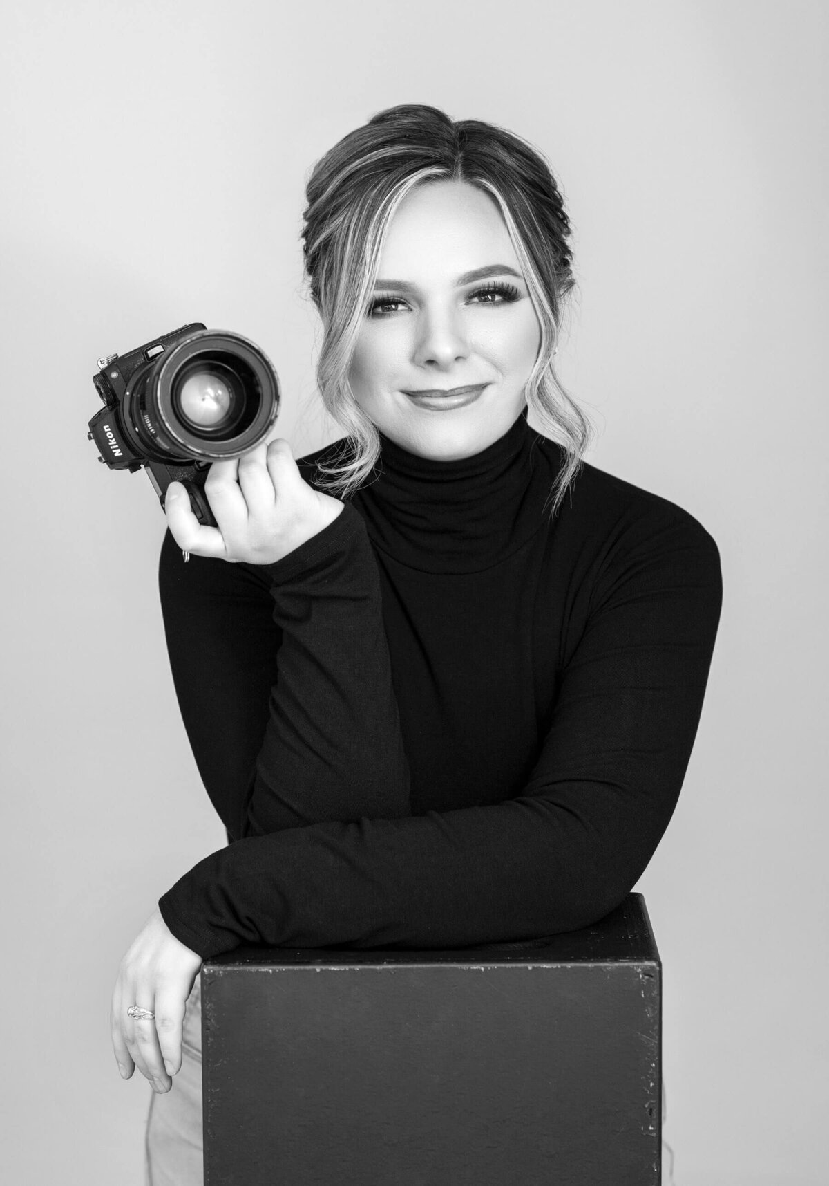 Black and white headshot of a photographer smiling at the camera.