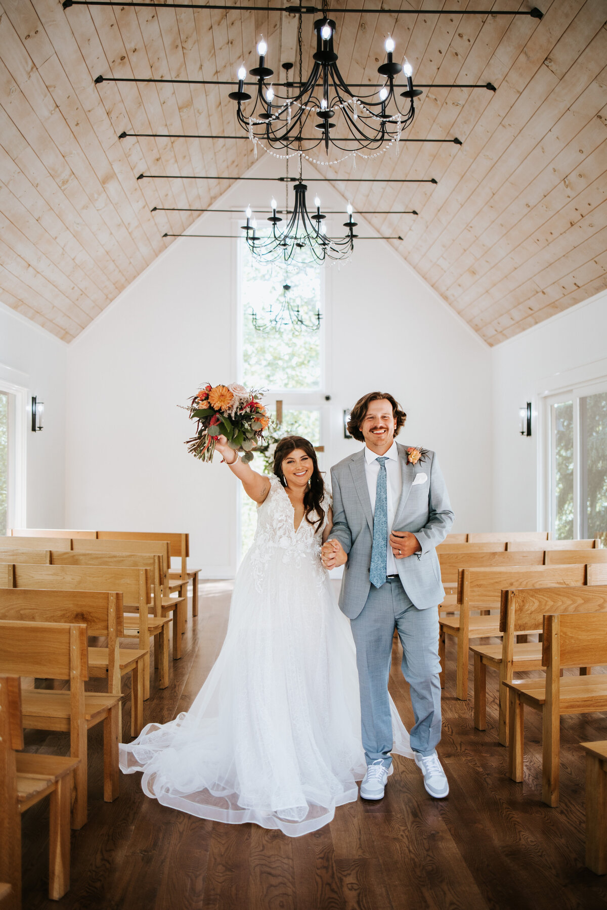 Bride and groom share a romantic moment inside Juliette Chapel, surrounded by soft light and elegant decor.