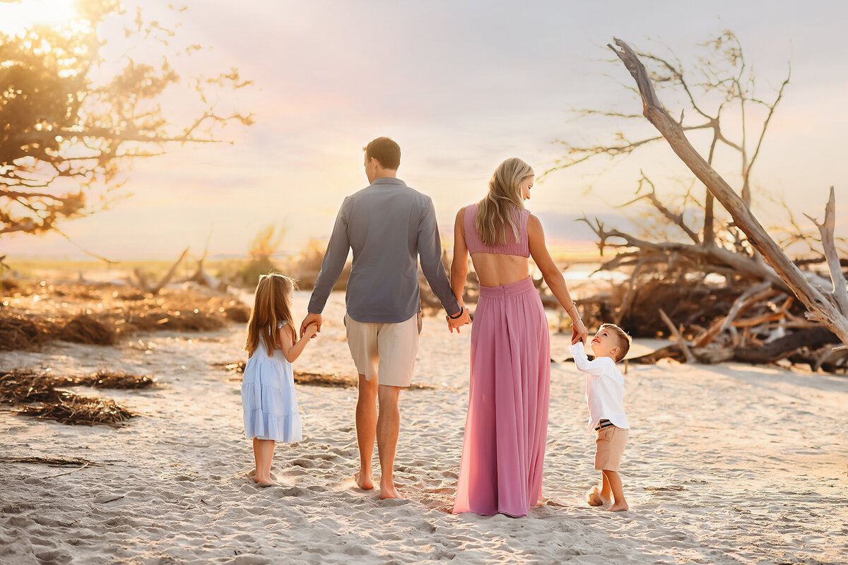 Family walks along the beach during Family Portraits on Folly Beach. 