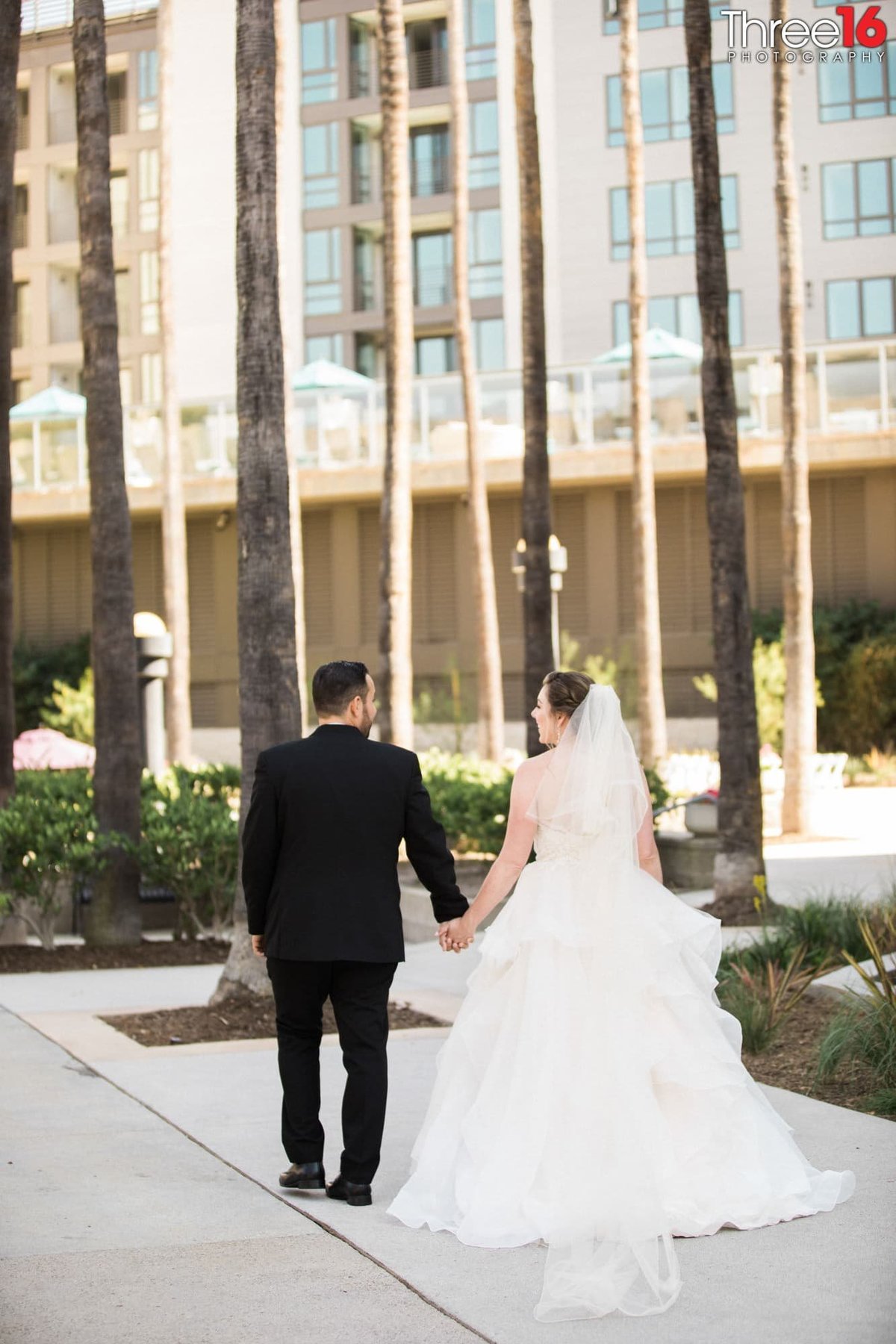 Bride and Groom go for a walk together hand in hand