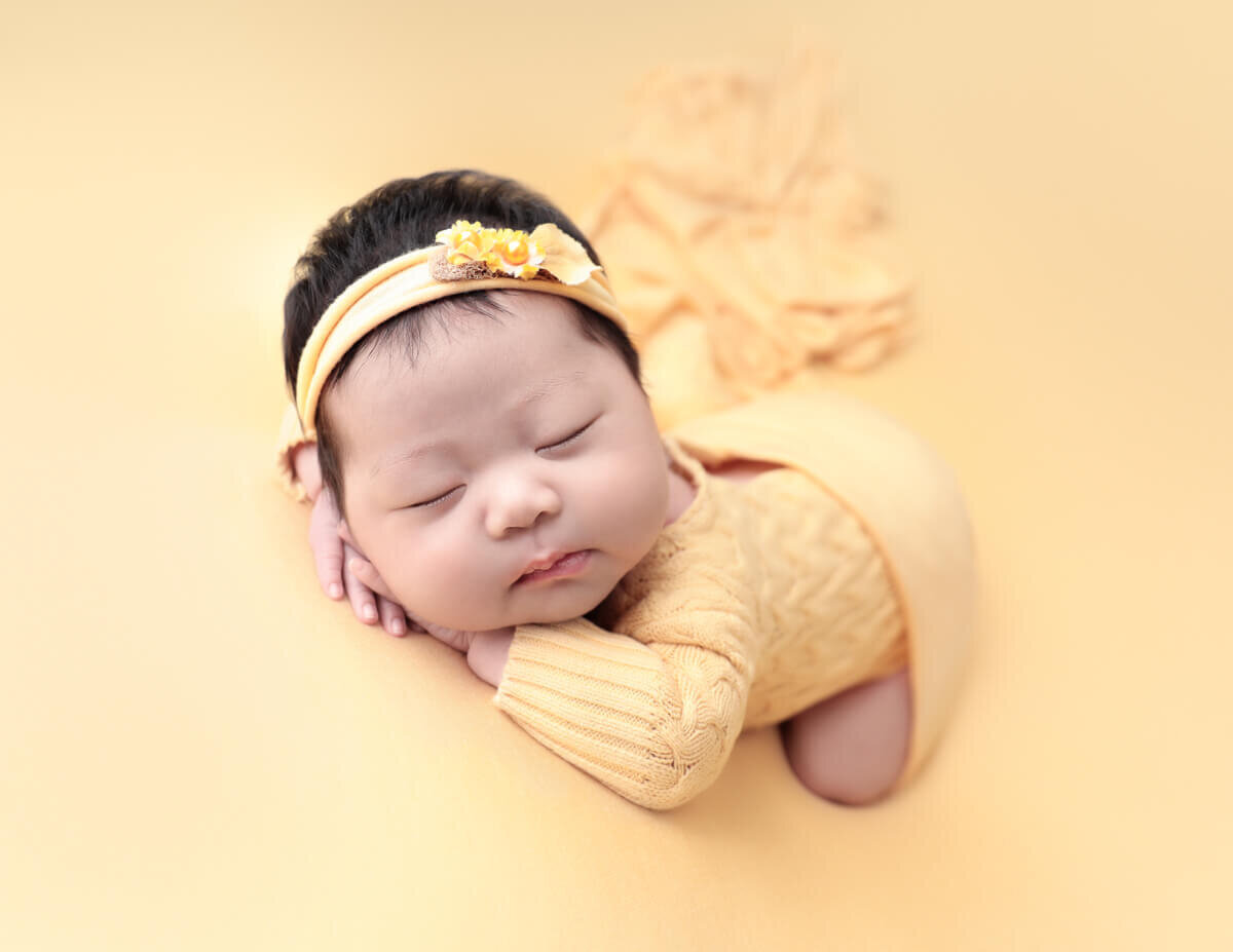Newborn girl posed at our Rochester, Ny studio.