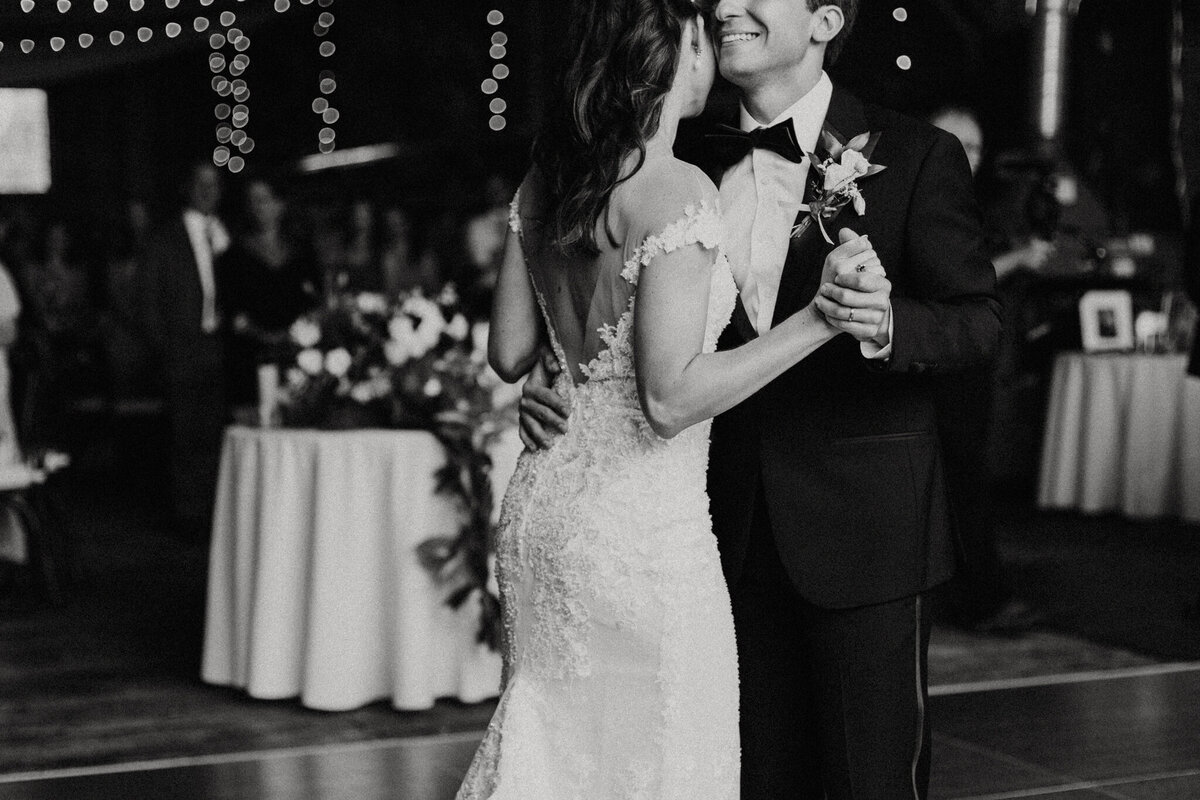 black and white image bride and groom  dancing