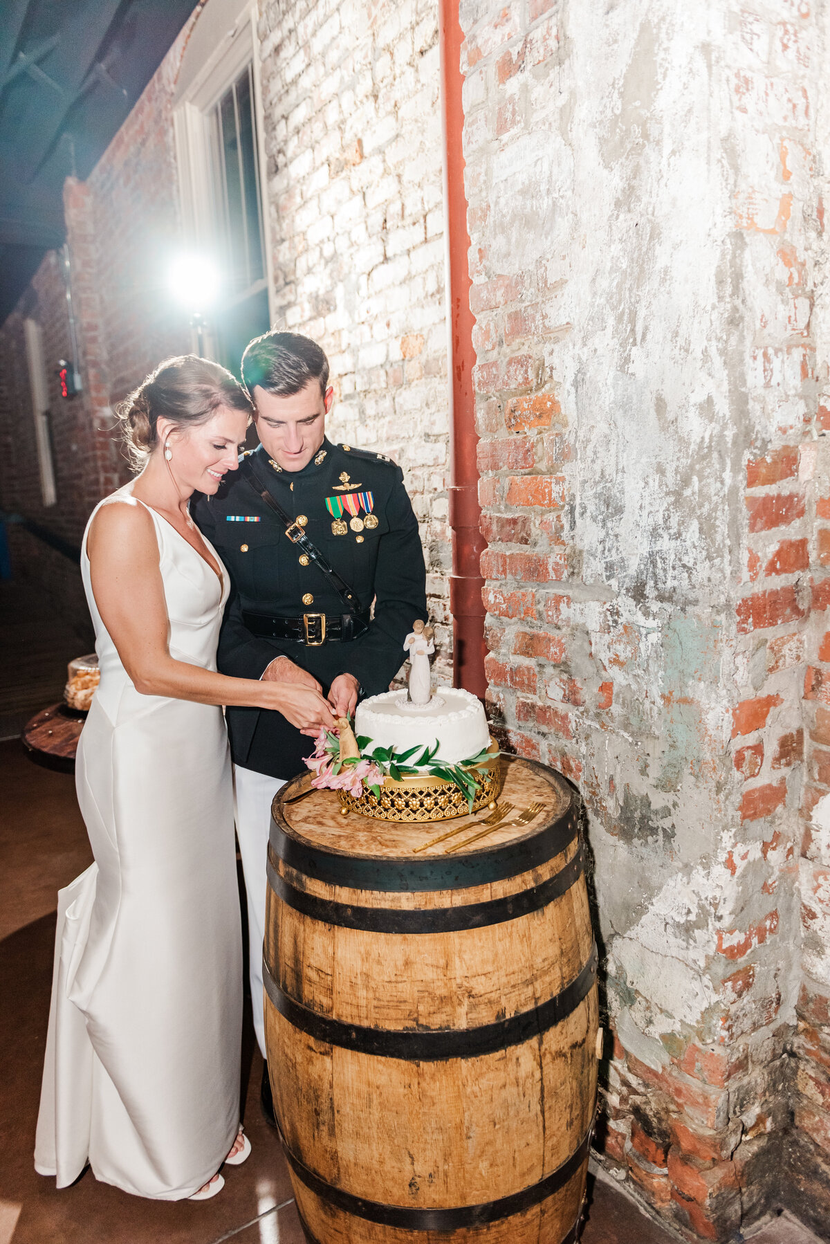couple cutting the cake during their wedding in wilmington, nc