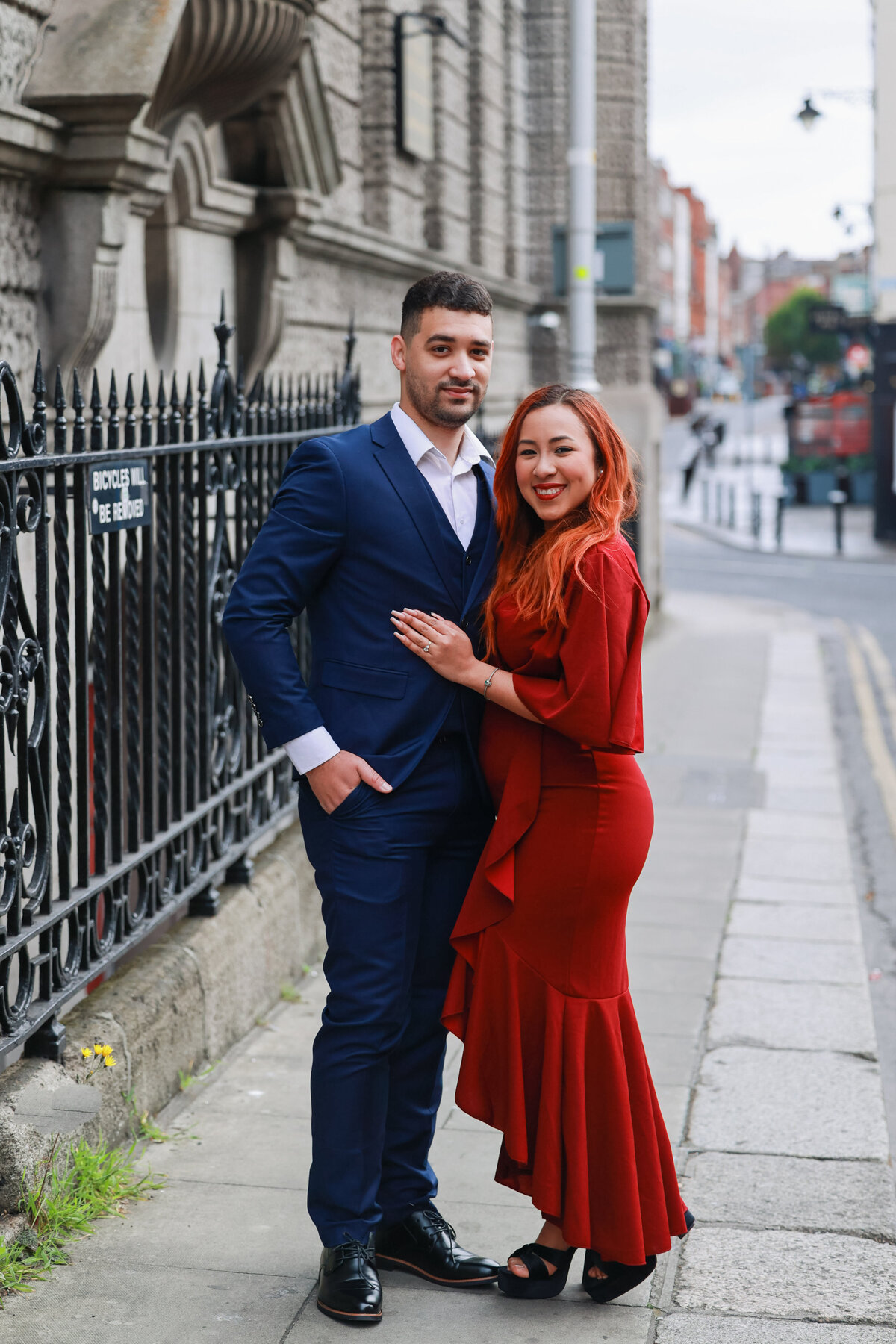 engaged man and woman hugging in the streets of dublin ireland by amanda richardson photography