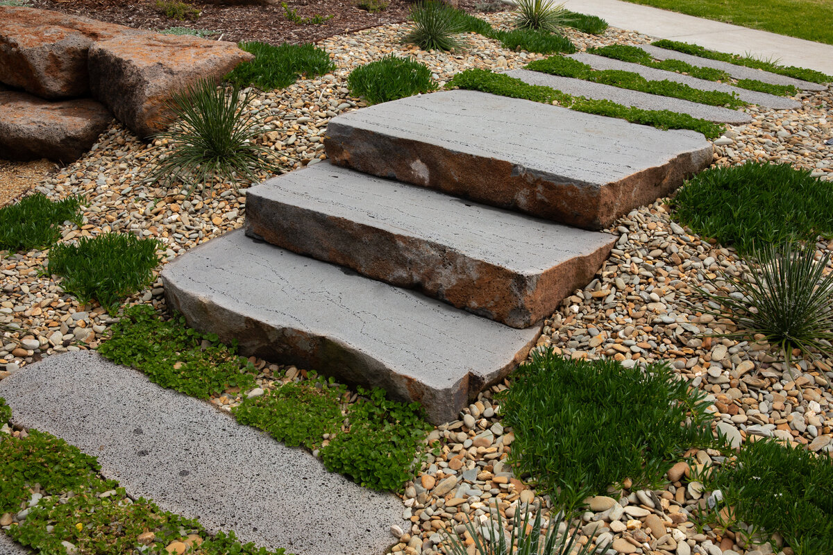 Rock work steps surrounded by greenery and paving by total landscapes & design